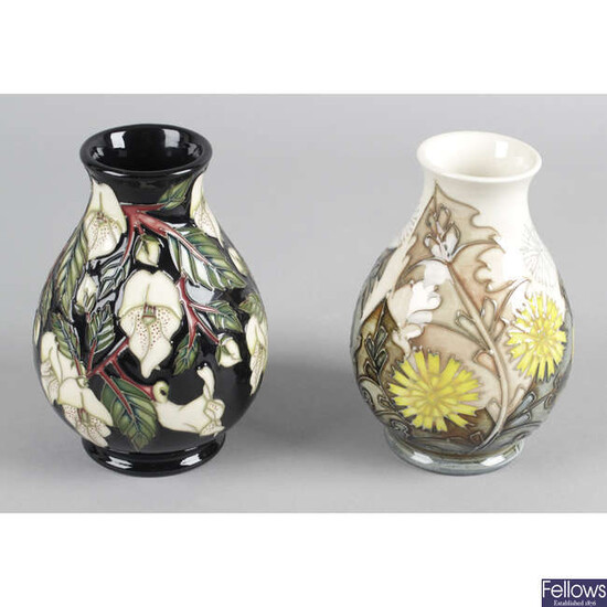 A Moorcroft pottery vase, in Dandelion pattern, together with another similar example in Mountain Gold pattern. (2).