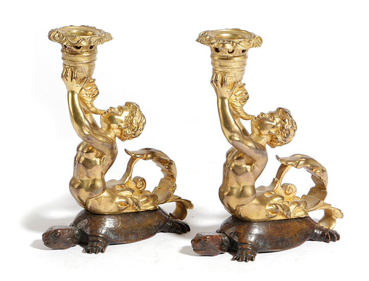 A PAIR OF GILT AND PATINATED BRONZE TRITON CANDLESTICKS