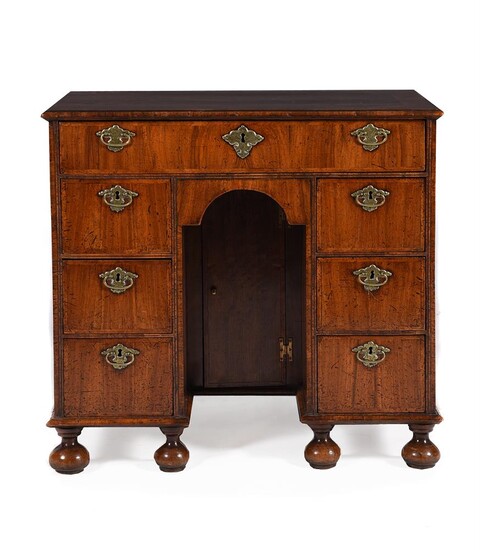 A QUEEN ANNE WALNUT AND FEATHER BANDED KNEEHOLE DESK, CIRCA 1710