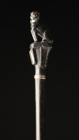 A Rare 19th Century Ebony Walking Cane; the handle carved in the form of a pug dog sat upon a tassel