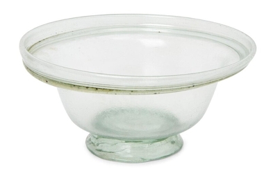 A Roman pale green glass bowl with collar rim and tooled ring base, circa 4th Century A.D., 13cm diam., 6.3cm high Provenance: Acquired by the current owner’s grandmother in the 1970s.