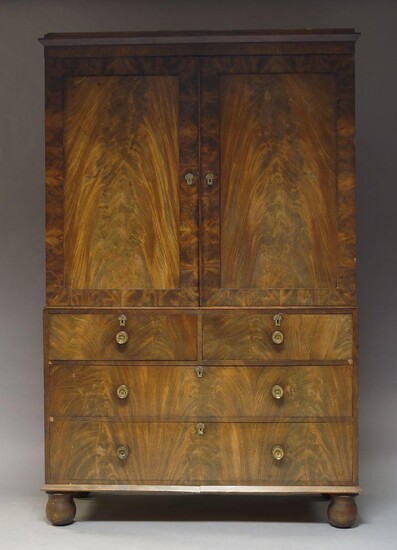 A Victorian flame mahogany linen press, the moulded cornice above...