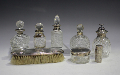 A Victorian silver mounted glass cylindrical scent bottle and stopper with hinged lid, engraved with