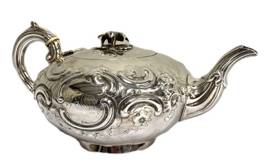 A Victorian silver teapot, hallmarked London 1850, of compressed oval form, with heavily embossed