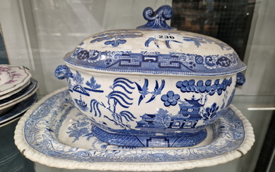 A WILLOW PATTERN SOUP TUREEN AND COVER, A BLUE AND WHITE PLATTER, TWO BLUE AND WHITE SOUP PLATES AND