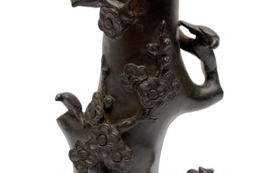A bronze prunus tree stem vase