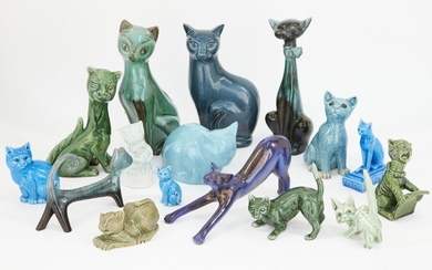 A collection of pottery cats glazed in greens and blues, to include two 19th century style Torquay cats including one singing from a hymn sheet, 15.5cm high, the other winking with glass eye, 23.5cm high, a large blue Poole pottery cat, 29cm high...