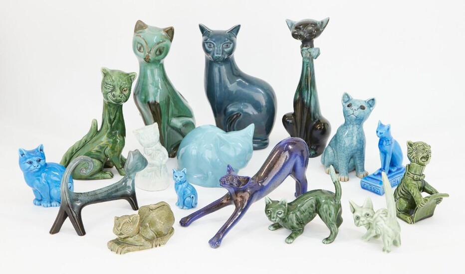 A collection of pottery cats glazed in greens and blues, to include two 19th century style Torquay cats including one singing from a hymn sheet, 15.5cm high, the other winking with glass eye, 23.5cm high, a large blue Poole pottery cat, 29cm high...