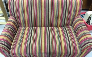 A contemporary two-seater sofa, upholstered in multi-coloured, striped fabric,...