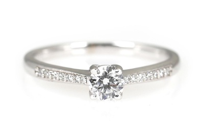 A diamond ring set with a brilliant-cut diamond weighing a total of...