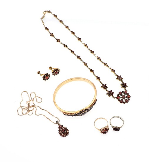 SOLD. A garnet jewellery set of silver, 8k and 14k gold and metal comprising two...