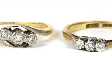 A gold three stone diamond ring