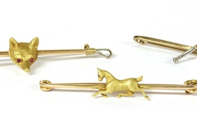 A group of gold equestrian brooches
