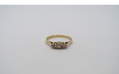 A hallmarked 18ct yellow gold three stone diamond ring, size...