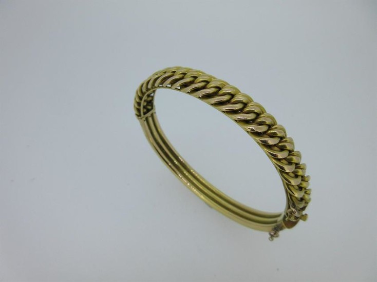 A hinged bangle with fixed chain link front stamped