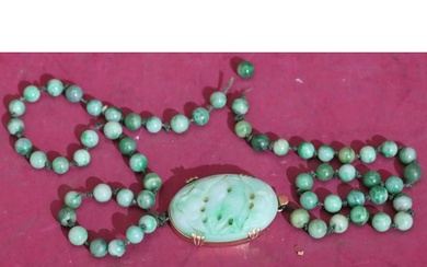 A jade bead necklace with oval jade and gold clasp, 40cm lon...