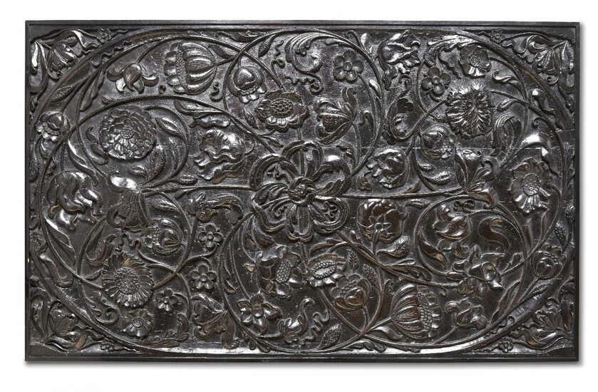 A large carved ebony panel, Batavia or Ceylon for the Dutch market, 1680-1720, 58 x 94cm. This fine quality, ebony panel, deeply carved in half relief, depicts a variety of flowers including tulips and sunflowers attached to tendrils which swirl...