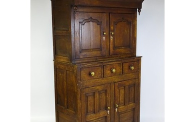 A late 18thC oak Welsh dueddarn cupboard with a moulded corn...