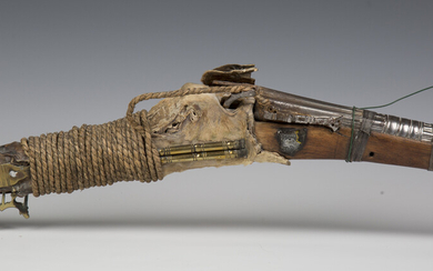 A late 19th century Middle Eastern matchlock rifle with cast and shaped barrel, barrel length 112cm