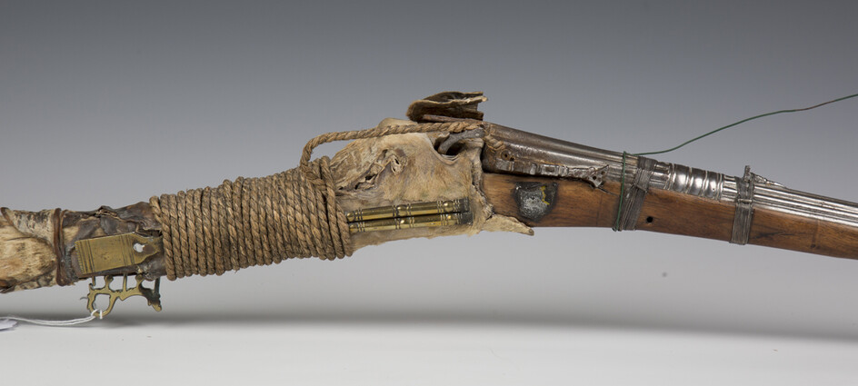 A late 19th century Middle Eastern matchlock rifle with cast and shaped barrel, barrel length 112cm