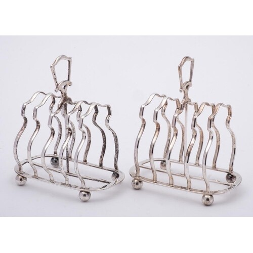 A pair of George V silver four-division toast racks, maker E...