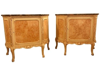 A pair of Hollywood Regency labeled 'Hostetler' faux painted Louis XV style cabinets or chests. Each