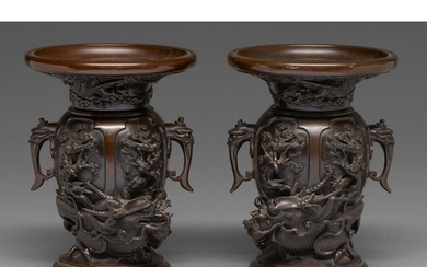 A pair of Japanese bronze dragon and phoenix vases, Meiji pe...