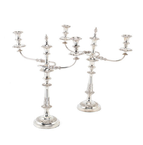 A pair of Old Sheffield plate three-light candelabra, and a pair of candlesticks en suite
