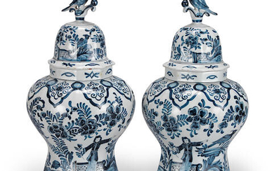 A pair of blue and white Delft vases and covers