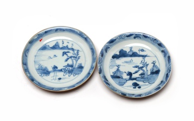 A pair of blue and white porcelain saucer, each painted to interior with landscape design