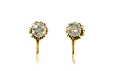A pair of gold single diamond earrings