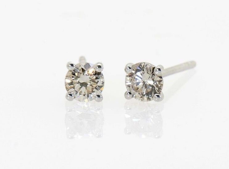 A pair of stud earrings with brilliant cut diamonds