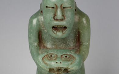 A pre-Columbian Olmec style carved green hardstone figure of a standing hunchback male, probably 900