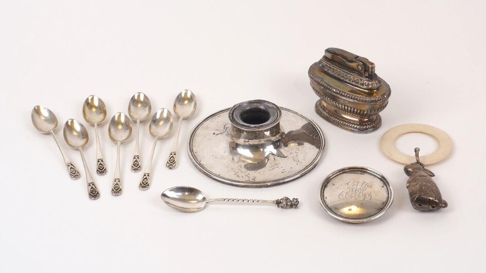 A silver inkwell, Birmingham, c.1916, A & J Zimmerman, with monogram to lid (damaged), together with a baby's rattle with horn ring and white metal rabbit dependent; a silver coffee spoon with devil terminal, Sheffield, c.1907; a set of seven...