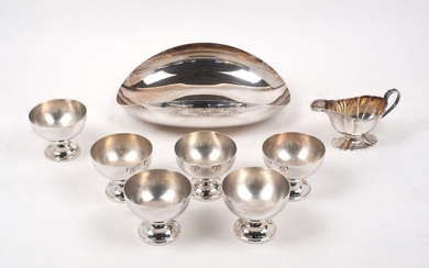 A small George V silver sauce boat, Sheffield, 1911, William Hutton & Sons, together with a contemporary Italian silver plated dish, of oval form with curved sides, 30cm long, and six silver plated nut bowls raised on pedestal feet, weighable...