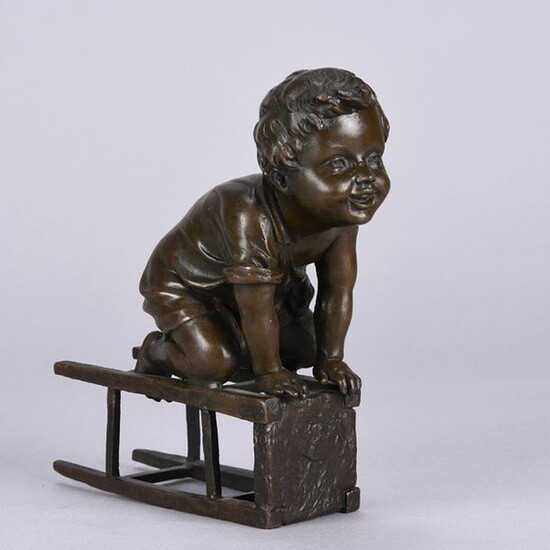 After Juan Clara (Spanish, 1875 ~ 1958) Bronze study of a young child climbing on a stool, signed and stamped with foundry seal. Mid 20th Century. Height 15 cm.