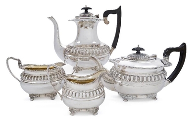 An Edwardian silver four-piece tea set, Chester, 1906, George Nathan & Ridley Hayes, each with part-lobed oval body raised on four paw bracket feet, the tea and coffee pots with angular handles and lobed finials to hinged lids, shell and gadrooned...