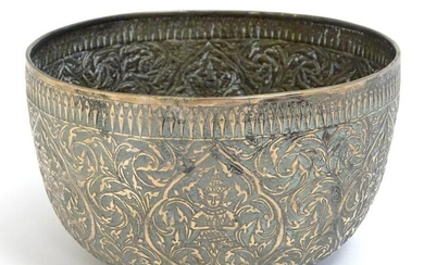 An Indian silver plate bowl with embossed scrolling