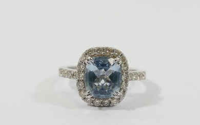 An aquamarine and diamond cluster ring, the mixed-cut cushio...
