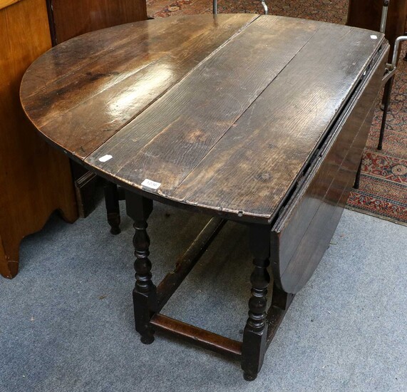 An early 19th century provincial oak gateleg dining table,...