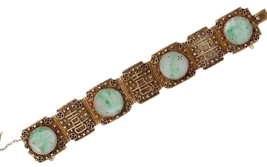 An early 20th century Chinese silver-gilt bracelet with jadeite jade plaques, the bracelet composed of seven hinged filigree panels three mounted with a circular carved jade discs, length 17.5cm Please note that the jade has not been tested for...