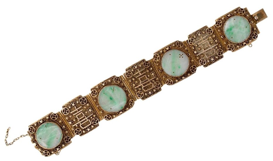 An early 20th century Chinese silver-gilt bracelet with jadeite jade plaques, the bracelet composed of seven hinged filigree panels three mounted with a circular carved jade discs, length 17.5cm Please note that the jade has not been tested for...