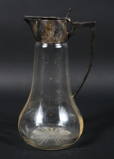 An early 20th century silver mounted glass claret jug, the base with star cut decoration