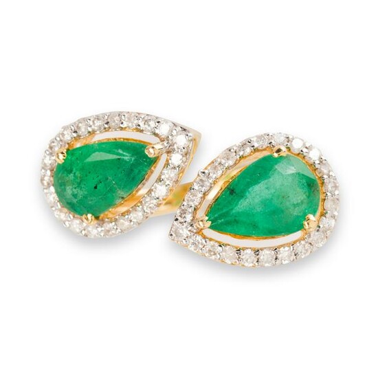 An emerald, diamond and eighteen karat gold ring