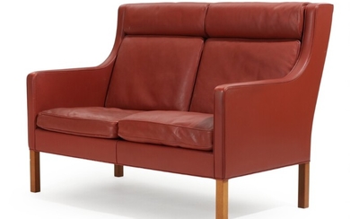 Børge Mogensen: High-backed two-seater sofa upholstered with red leather, mahogany legs. Manufactured by Fredericia Furniture. L. 130 cm.
