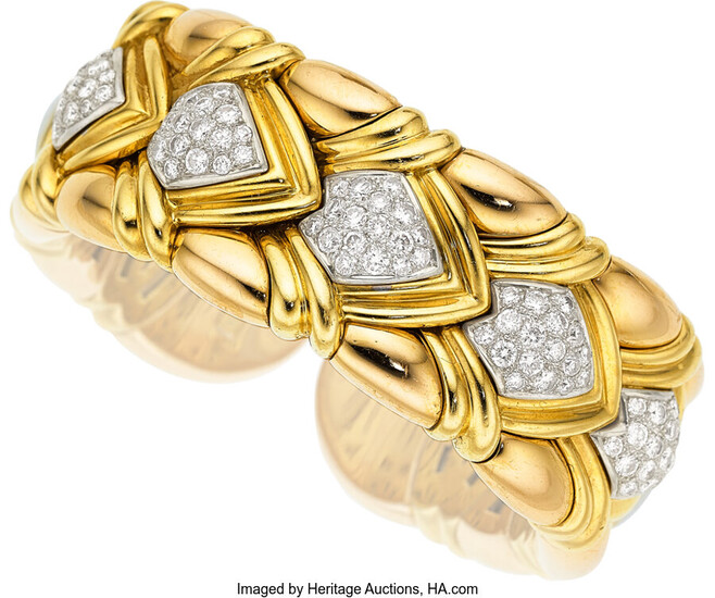 Diamond, Gold Bracelet The flexible cuff features full-cut diamonds...
