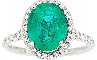 Emerald, Diamond, White Gold Ring Stones: Oval-shaped emerald weighing...