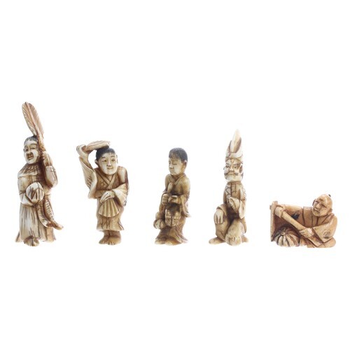 Four small Japanese stained ivory figural okimono and a nets...