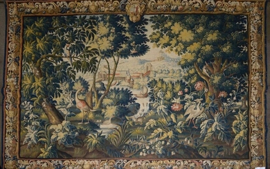 Important Aubusson tapestry in wool and silk with "Ducks, parrot and waders in a greenery on a background of landscape at the castle". Topped with the coat of arms of the Blumenstein family. Bearing in the lower right-hand corner the signature of the...