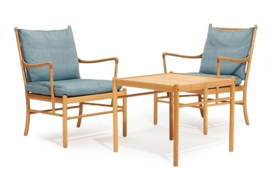Ole Wanscher: “Colonial Chair”. A pair of cherry wood armchairs and a square table, loose cushions with blue fabric. Table H. 52. L. 60. W. 60 cm. (3)